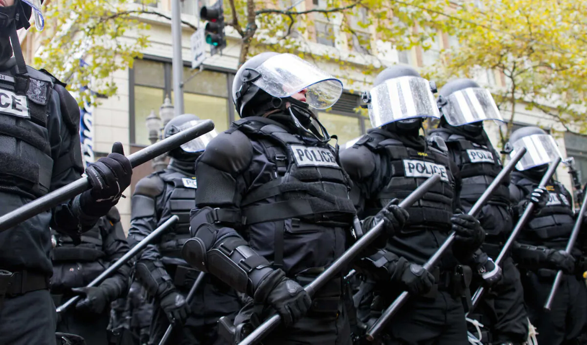 Police in riot gear hold the line in downtown Portland, Ore., during an Occupy Portland protest on the first anniversary of Occupy Wall Street on Nov. 17, 2011. (JPL Designs/Shutterstock)