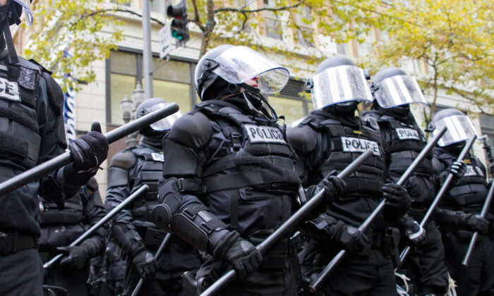 Police in riot gear hold the line in downtown Portland, Ore., during an Occupy Portland protest on the first anniversary of Occupy Wall Street on Nov. 17, 2011. (JPL Designs/Shutterstock)