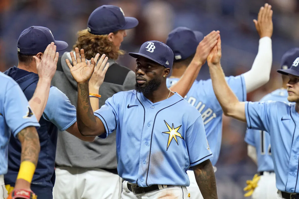 Tampa Bay Rays' Randy Arozarena, center, high fives teammates after the team defeated the Los Angeles Angels during a baseball game Monday, Aug. 22, 2022, in St. Petersburg, Fla. (Chris O'Meara/AP Photo)