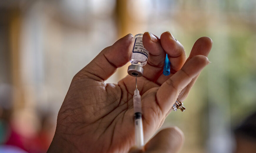A health care worker prepares a dose of Pfizer BioNTech COVID-19 vaccine. (Ezra Acayan/Getty Images)