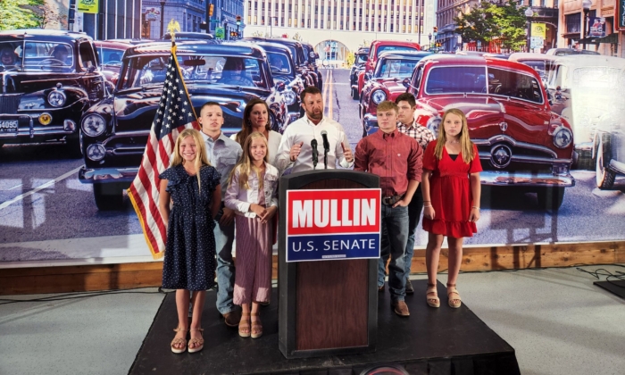 Rep. Markwayne Mullin is joined by his family during his victory speech in Tulsa on Aug. 23 after winning the Oklahoma GOP primary runoff. (Jeff Louderback/The Epoch Times)