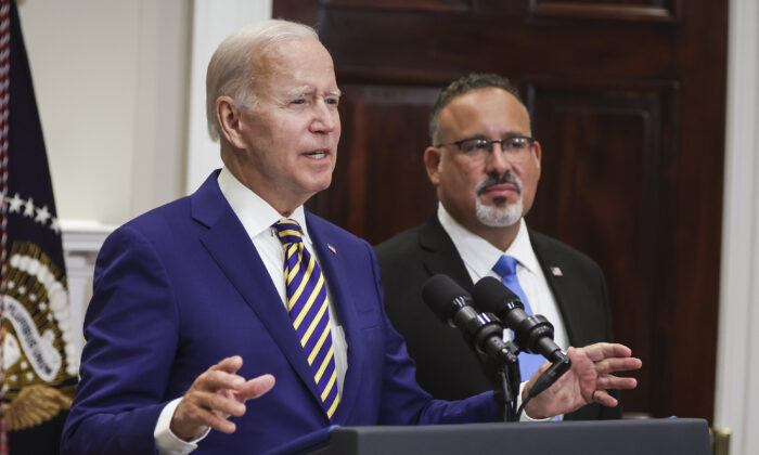 President Joe Biden (L), joined by Education Secretary Miguel Cardona, speaks on student loan debt in the Roosevelt Room of the White House on Aug. 24, 2022. (Alex Wong/Getty Images)