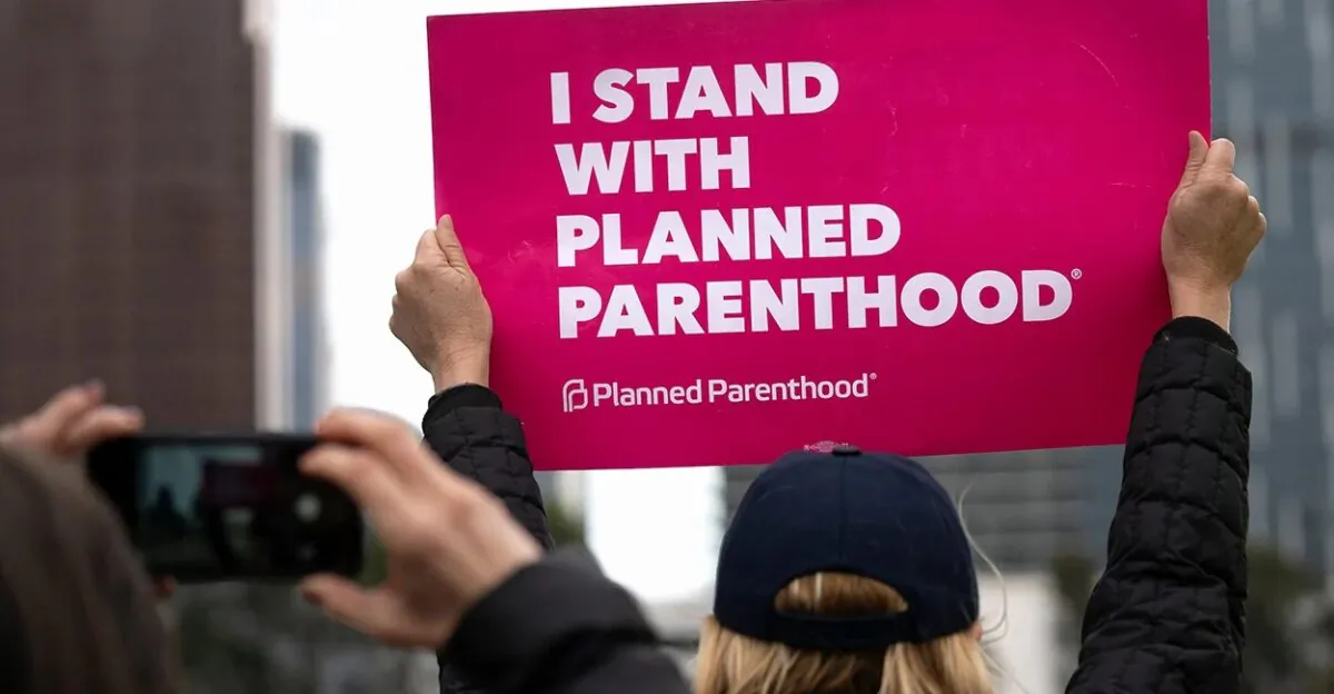 An activist holds a sign supporting Planned Parenthood, in Los Angeles on May 21, 2019. (Ronen Tivony/Getty Images)