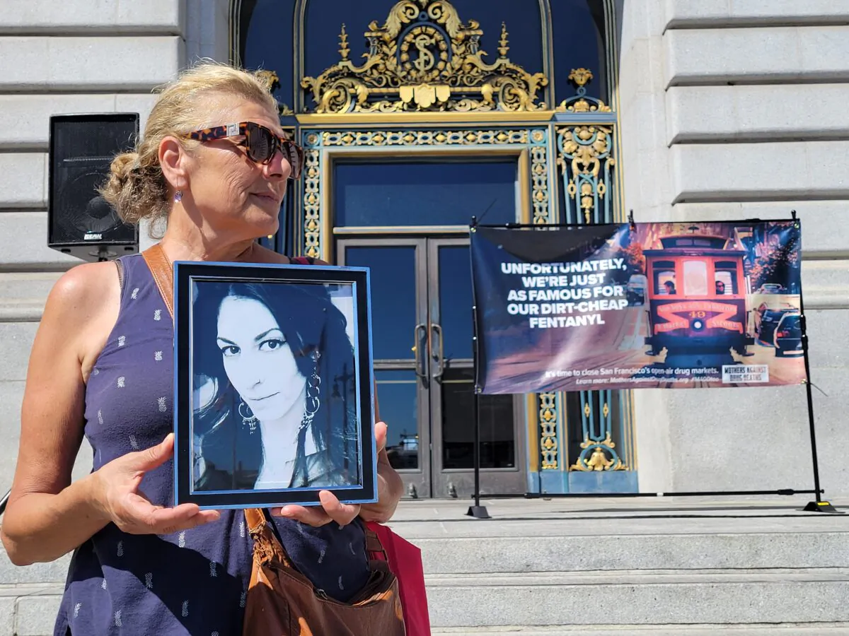 A mother attends a rally in front of City Hall in San Francisco on Aug. 21, 2022, for National Fentanyl Prevention and Awareness Day. (Jason Blair/NTD)