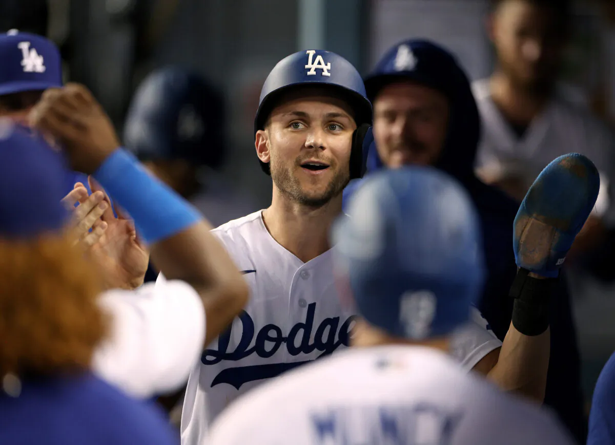 Trea Turner (6) of the Los Angeles Dodgers celebrates his run in the dugout, to take a 6–2 lead over the Milwaukee Brewers, during the fourth inning at Dodger Stadium in Los Angeles, August 24, 2022. (Harry How/Getty Images)