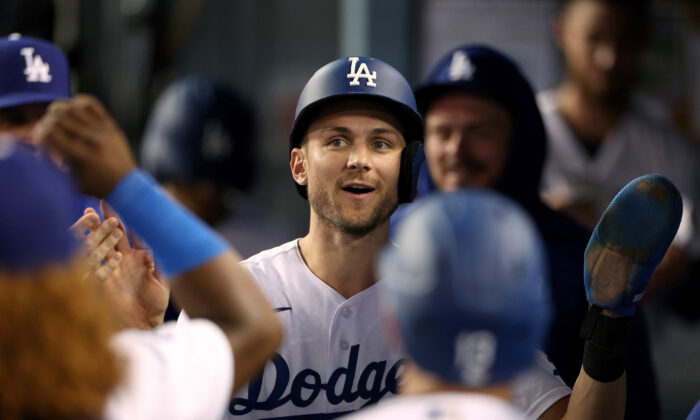Trea Turner (6) of the Los Angeles Dodgers celebrates his run in the dugout, to take a 6–2 lead over the Milwaukee Brewers, during the fourth inning at Dodger Stadium in Los Angeles, August 24, 2022. (Harry How/Getty Images)