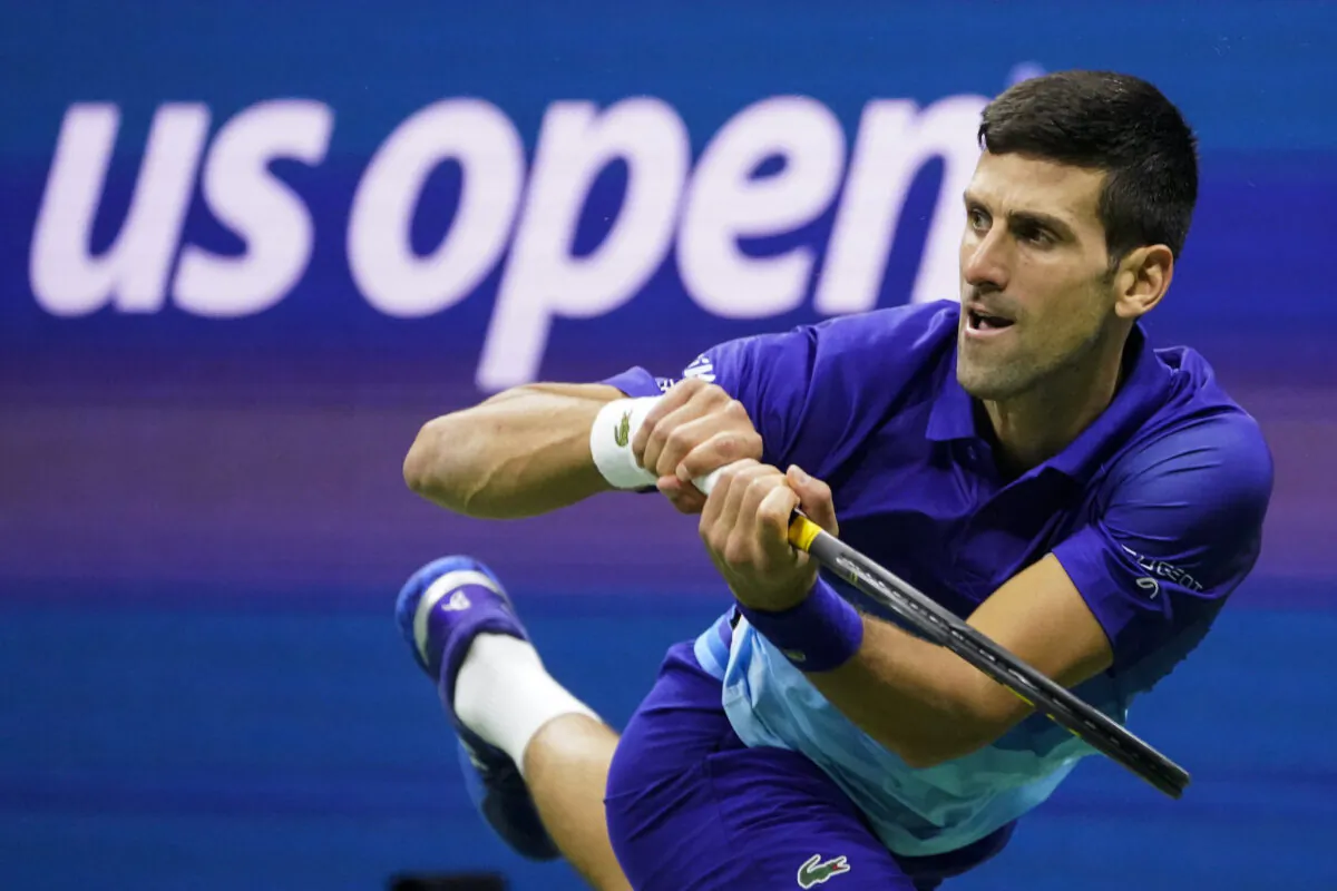 Novak Djokovic of Serbia returns a shot to Alexander Zverev of Germany during the semifinals of the U.S. Open tennis championships in New York on Sept. 10, 2021. (John Minchillo/AP Photo)