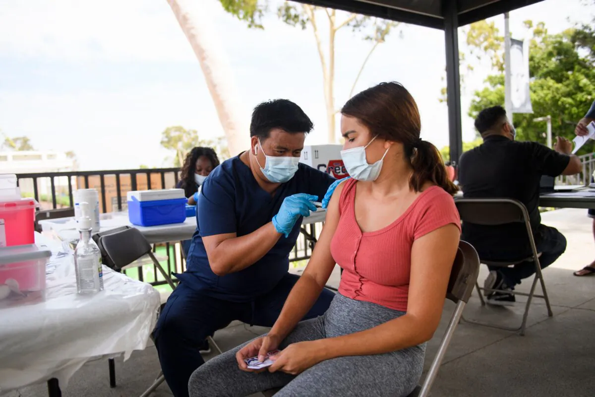 A college student gets a COVID-19 vaccine at the California State University Long Beach in Long Beach, Calif., on Aug. 11, 2021. (Patrick T. Fallon/AFP via Getty Images)