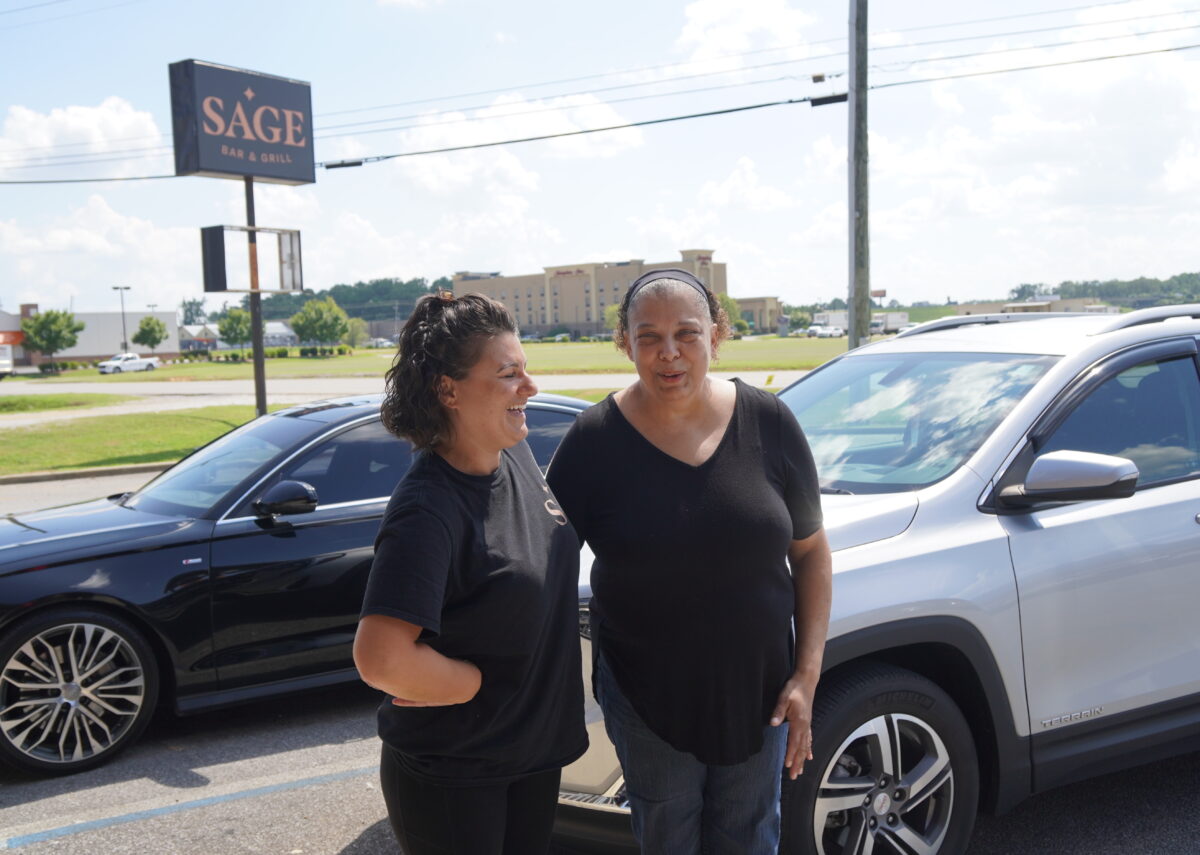 Katie Troncale (L) and Joyce King stand outside the Sage Bar & Grill in Calera, Ala. in July 2022 (Jann Falkenstern / The Epoch Times)
