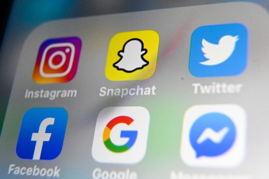 The logos of mobile apps Instagram, Snapchat, Twitter, Facebook, Google, and Messenger displayed on a tablet on Oct. 1, 2019. (Denis Charlet/AFP via Getty Images)