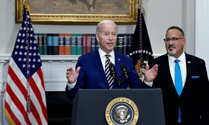 President Joe Biden announces student loan relief with Education Secretary Miguel Cardona (R) in the Roosevelt Room of the White House in Washington, on Aug. 24, 2022. (Olivier Douliery/AFP via Getty Images)