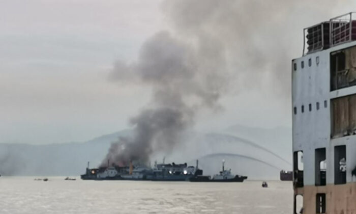 Smoke rises from the M/V Asia Philippines, an inter-island cargo and passenger vessel, as it caught fire while approaching Batangas port, southern Philippines, on Aug. 26, 2022. (Philippine Coast Guard via AP)