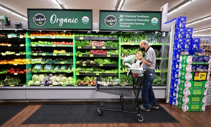 A shopper looks at organic produce at a supermarket in Montebello, Calif., on Aug. 23, 2022. (Frederic J. Brown/AFP via Getty Images)