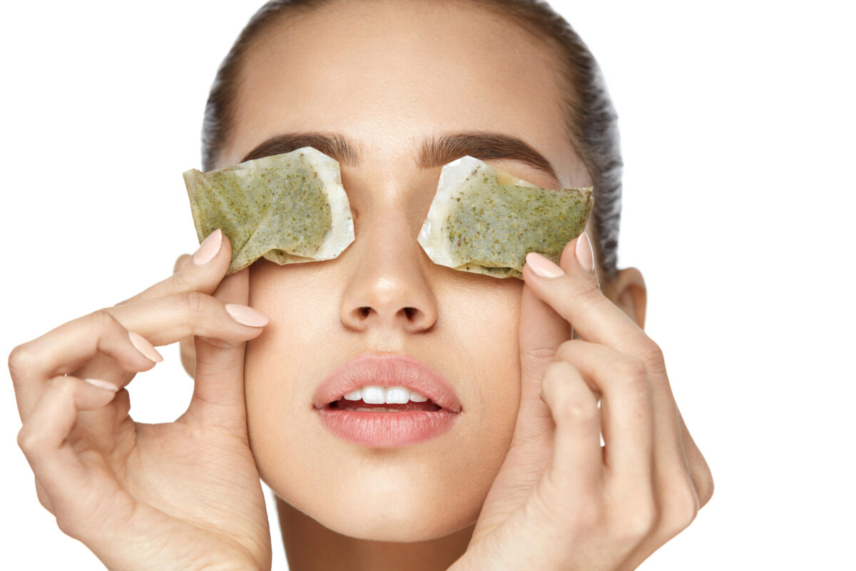 Drinking green tea can be helpful in improving eye bags as the catechins can boost blood flow to the skin and slow aging. You can also apply used, cooled tea bags to the under eyes. (puhhha/Shutterstock)