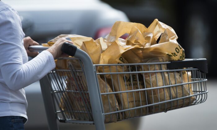A woman leaves a grocery store in Mississauga, Ont., in a file photo. (The Canadian Press/Nathan Denette)