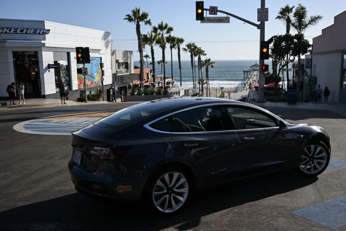 A Tesla electric vehicle makes a turn in Manhattan Beach, Calif. on June 14, 2022. (Patrick T. Fallon/AFP via Getty Images)