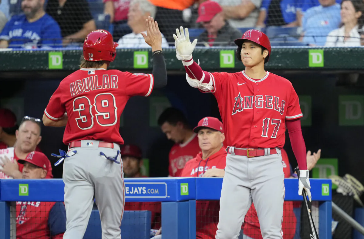 Ryan Aguilar #39 of the Los Angeles Angels celebrates after scoring with Shohei Ohtani #17 against the Toronto Blue Jays in the second inning during their MLB game at the Rogers Centre in Toronto, Ontario, Canada, on August 26, 2022. (Mark Blinch/Getty Images)