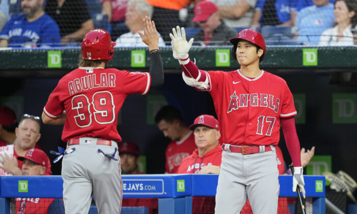 Ryan Aguilar #39 of the Los Angeles Angels celebrates after scoring with Shohei Ohtani #17 against the Toronto Blue Jays in the second inning during their MLB game at the Rogers Centre in Toronto, Ontario, Canada, on August 26, 2022. (Mark Blinch/Getty Images)
