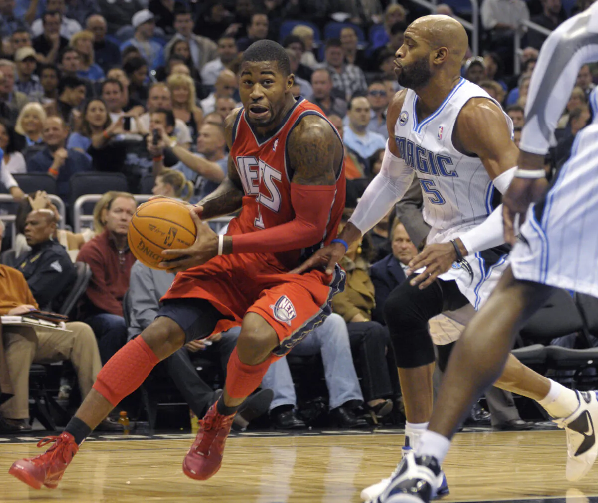 New Jersey Nets guard Terrence Williams (L) drives past Orlando Magic guard Vince Carter during the first half of an NBA basketball game in Orlando, Fla., on Nov. 5, 2010. (Phelan M. Ebenhack/AP Photo)