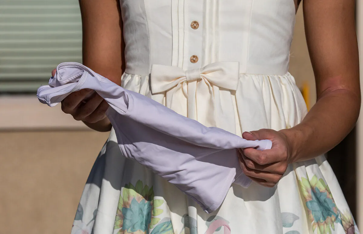 U.S. ex-transgender teen Chloe Cole holds a body brace that she used while she was taking transgender hormonal treatments, in Northern California on Aug. 26, 2022. (John Fredricks/The Epoch Times)