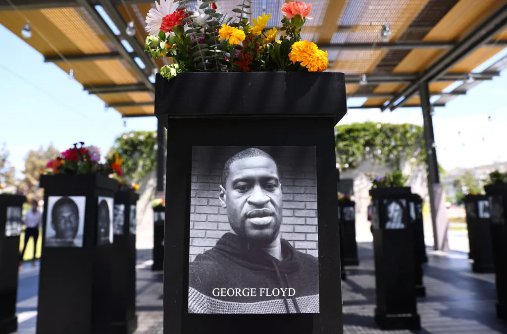 A photograph of George Floyd (C) is displayed along with other photographs at the Say Their Names memorial exhibit at Martin Luther King Jr. Promenade on July 20, 2021, in San Diego. (Mario Tama/Getty Images)