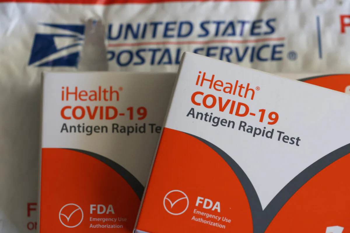 Free iHealth COVID-19 antigen rapid tests from the federal government sit on a U.S. Postal Service envelope after being delivered in San Anselmo, Calif. on Feb. 04, 2022. (Justin Sullivan/Getty Images)