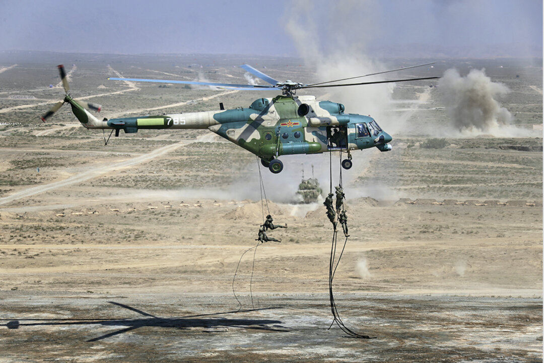 Troops disembark from a Chinese military helicopter during joint war games held by Russia and China held in northwestern China on Aug. 13, 2021. (Savitskiy Vadim/Russian Defense Ministry Press Service via AP)