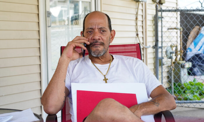 Domingo Ramos answers a phone call from Melissa Hadden, mother of missing Port Jervis woman Heather Callas, in front of his house in Middletown, N.Y., on Aug. 25, 2022. (Cara Ding/The Epoch Times)