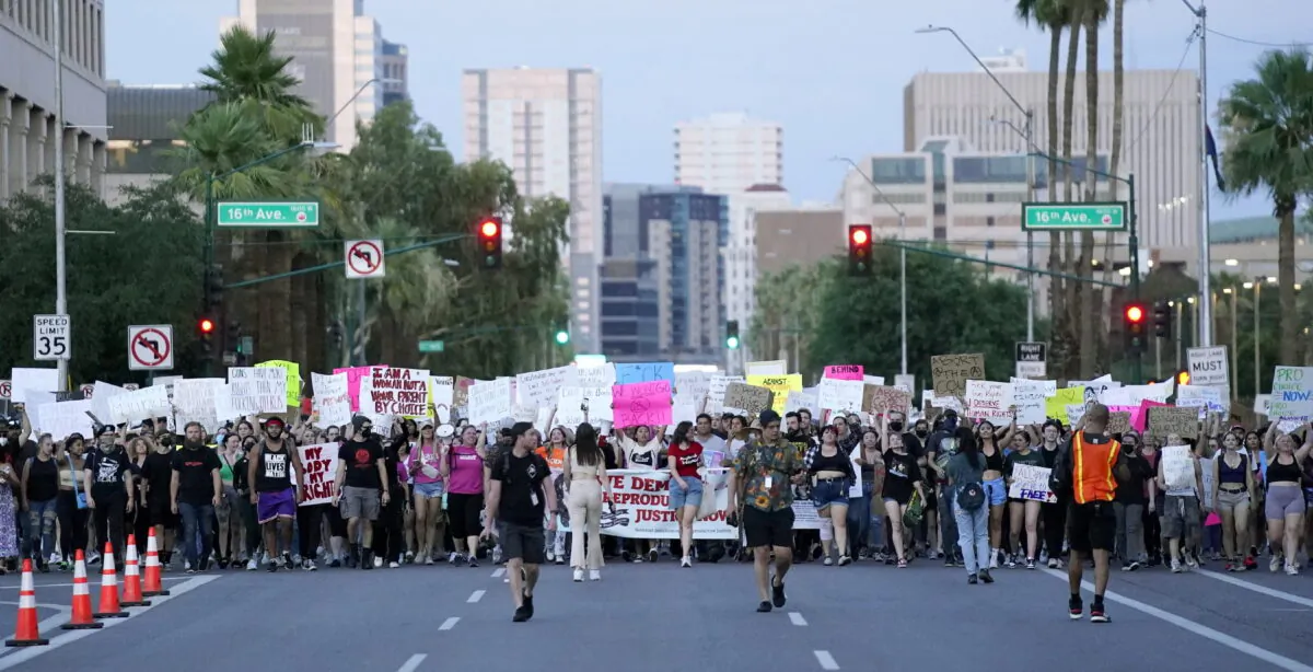 Thousands of protesters march around the Arizona Capitol in Phoenix after the Supreme Court decision to overturn the landmark Roe v. Wade abortion ruling on June 24, 2022. (Ross D. Franklin/AP Photo)