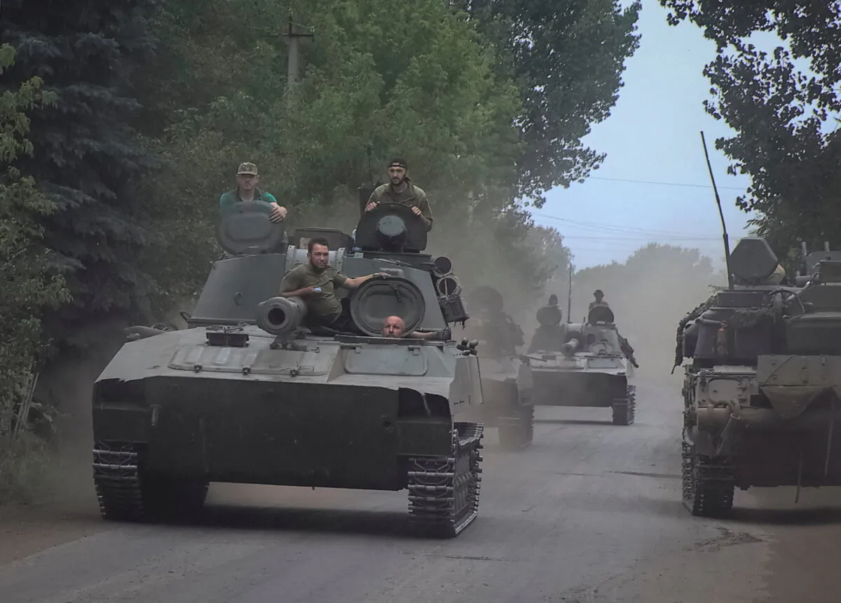 Ukrainian servicemen ride self-propelled howitzers not far from front line, amid Russia's attack on Ukraine, in the Donetsk region, Ukraine on Aug. 12, 2022. (Reuters/Stringer)
