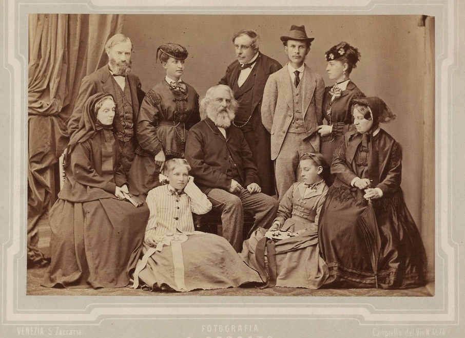 The family
of Henry Wadsworth
Longfellow poses
for a photographer
in Venice, 1869.
Longfellow is seated
center. Of those
standing, his son
Ernest is second from
right and his eldest
daughter Alice Mary
is second from left.
His daughters Edith
and Anne Allegra sit
on the ground. (Public domain)