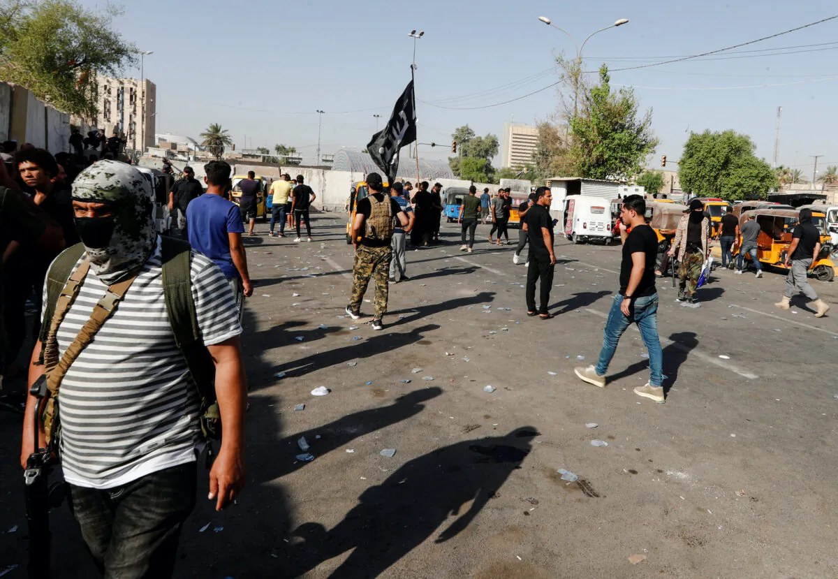 Members of Sadr's Peace Brigades fighters gather during clashes with the Iraqi security forces near the Green Zone, in Baghdad, Iraq, on Aug. 30, 2022. (Thaier Al-Sudani/Reuters)