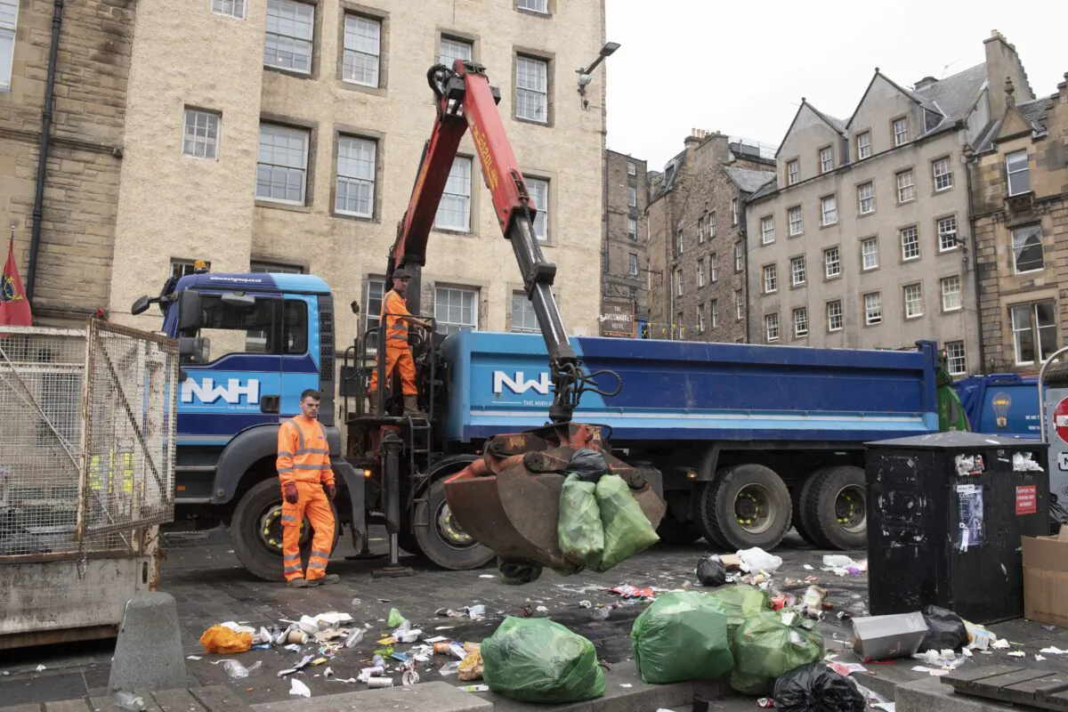 Edinburgh's waste workers clearing mountains of rubbish at the Grassmarket as they return to work following their 11 days of industrial action, in Edinburgh, Scotland, on Aug. 30, 2022. (Lesley Martin/PA Media)