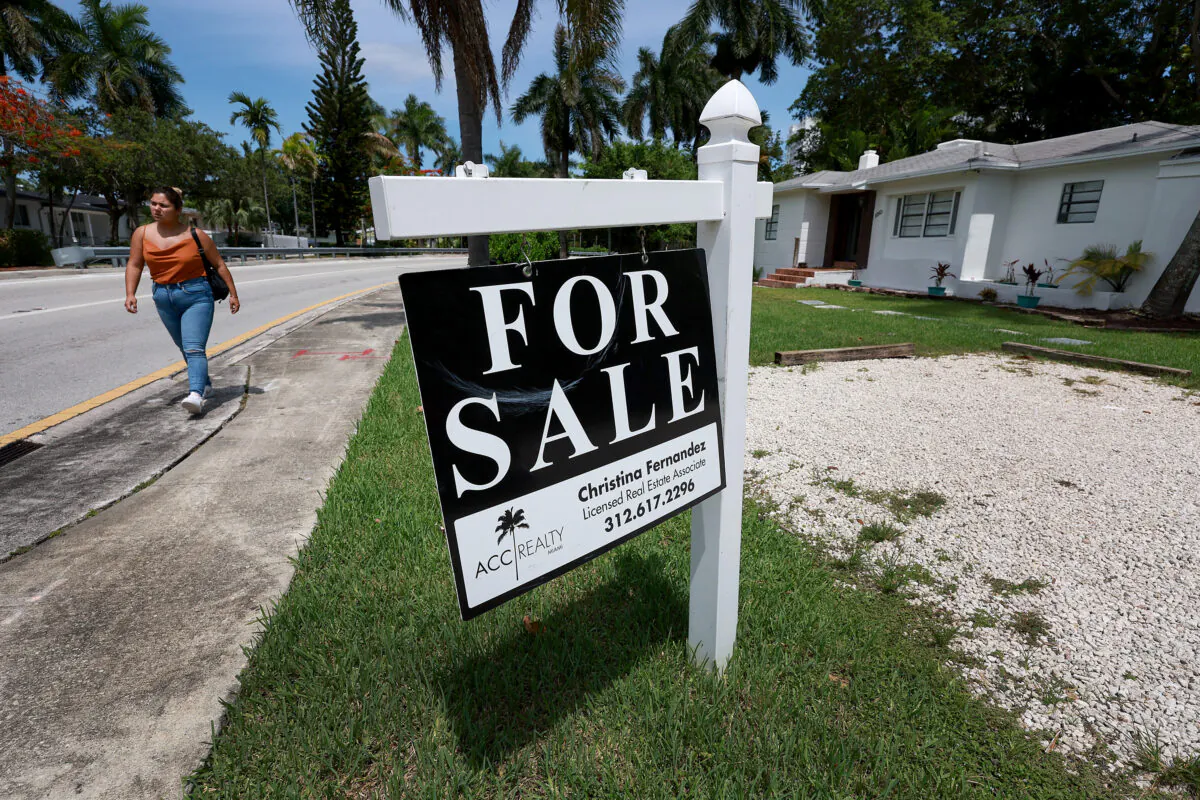 A 'For Sale' sign hangs in front of a home in Miami, Fla., on June 21, 2022. (Joe Raedle/Getty Images)