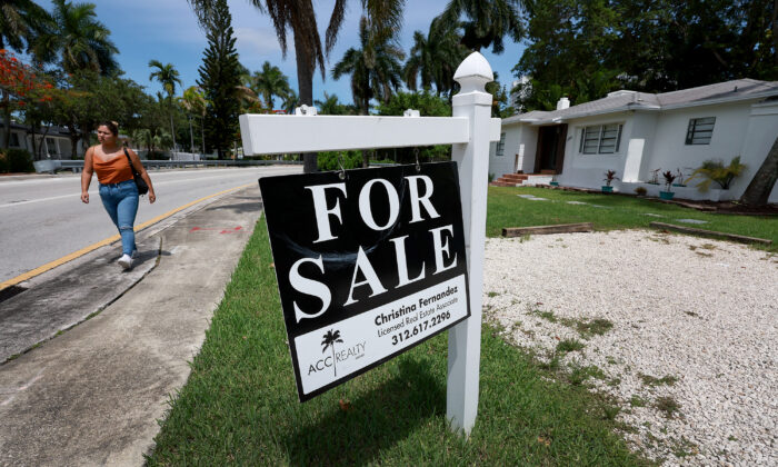 A 'For Sale' sign hangs in front of a home in Miami, Fla., on June 21, 2022. (Joe Raedle/Getty Images)