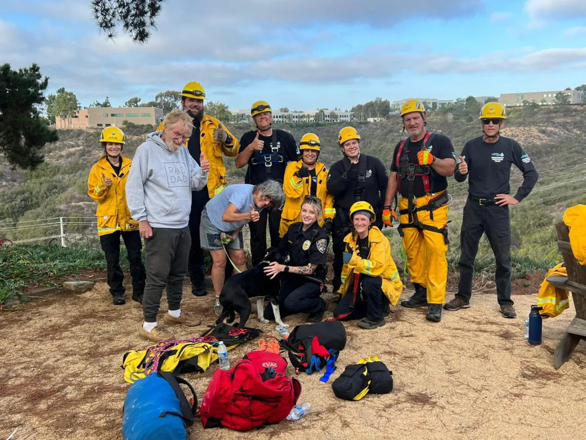 Group photo of San Diego Humane Society members, dog, and dog's owner taken after deaf dog, Hobo, had been rescued from a ravine in Sorrento Valley in San Diego, Calif., on Aug. 29, 2022. (Courtesy of San Diego Humane Society)