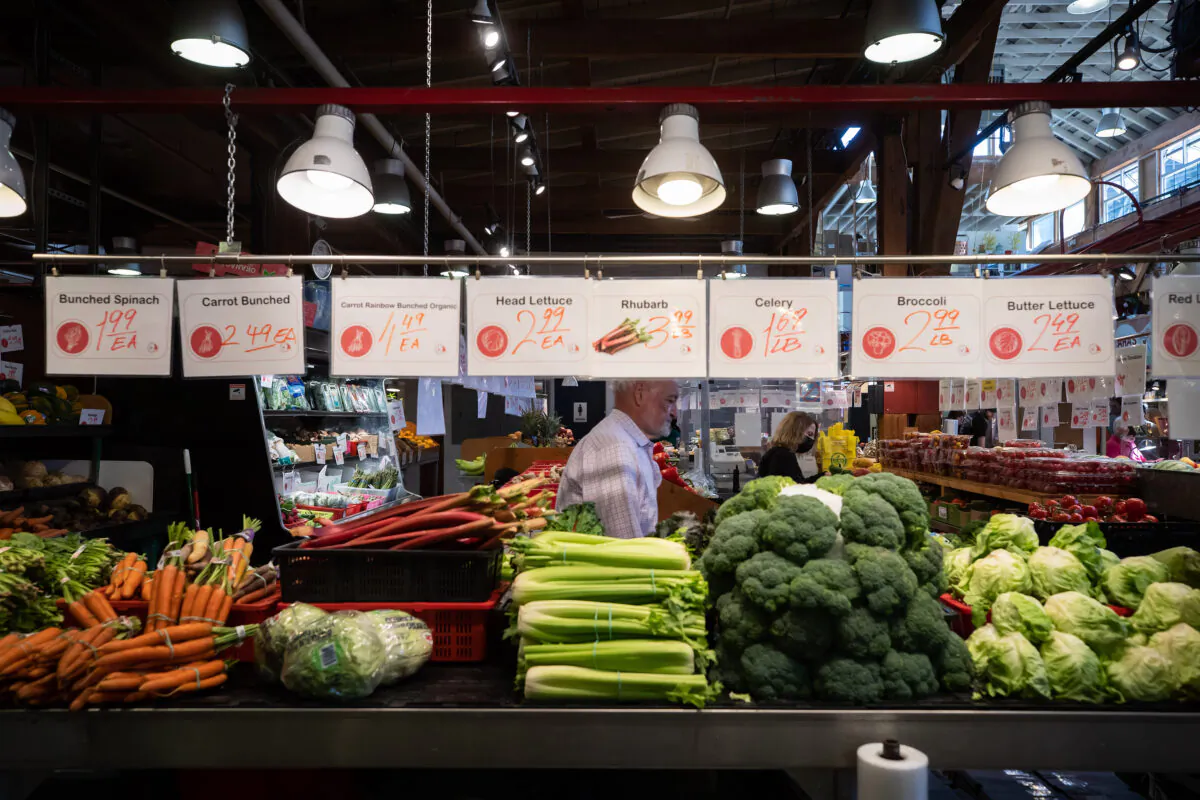 People shop for produce at the Granville Island Market in Vancouver, on July 20, 2022. Canada's inflation rate was up 8.1 percent in June compared with a year ago, its largest yearly change since January 1983. (The Canadian Press/Darryl Dyck)