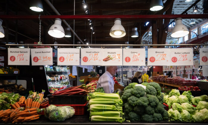 People shop for produce at the Granville Island Market in Vancouver, on July 20, 2022. Canada's inflation rate was up 8.1 percent in June compared with a year ago, its largest yearly change since January 1983. (The Canadian Press/Darryl Dyck)