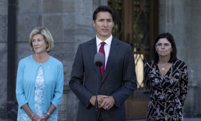 Public Services and Procurement Minister Helena Jaczek (left) and Federal Economic Development Agency for Southern Ontario Minister Filomena Tassi look on as Prime Minister Justin Trudeau responds to a question following a cabinet shuffle at Rideau Hall, on Aug. 31, 2022 in Ottawa. (Adrian Wyld/The Canadian Press)