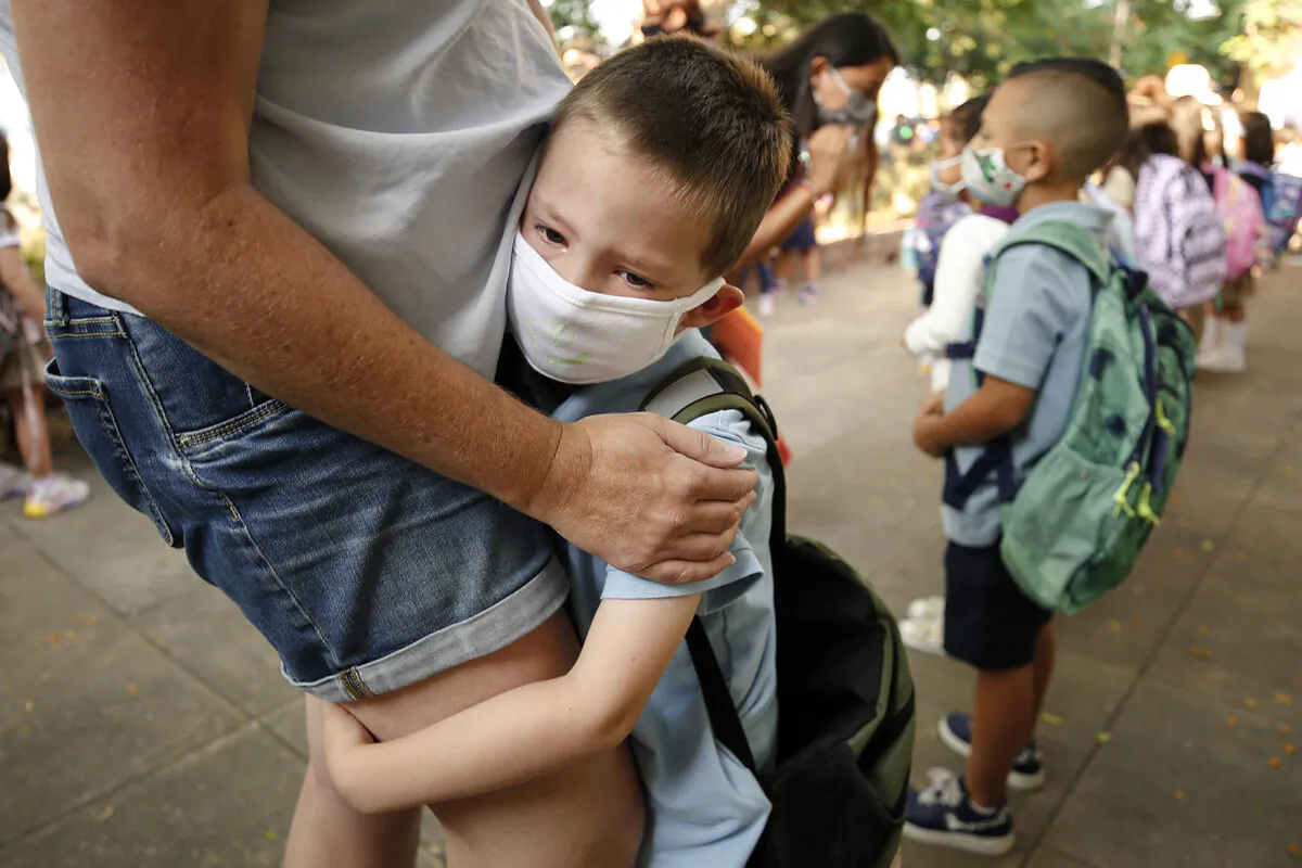 August Russell clings to his mother, Natalie Russell, on his first day of kindergarten in Altadena, Calif., in August 2021. (Al Seib/Los Angeles Times/TNS)