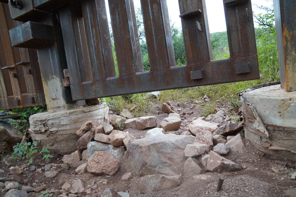 A large gap in the border wall fence provides easy access for illegal migrants crossing into the United States from Mexico near Douglas, Ariz., on Aug. 24. (Allan Stein/The Epoch Times)