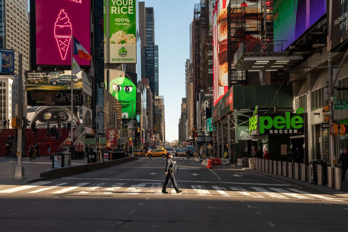 A police officer crosses the street in a nearly empty Times Square in New York on March 12, 2020. (David Dee Delgado/Getty Images)
