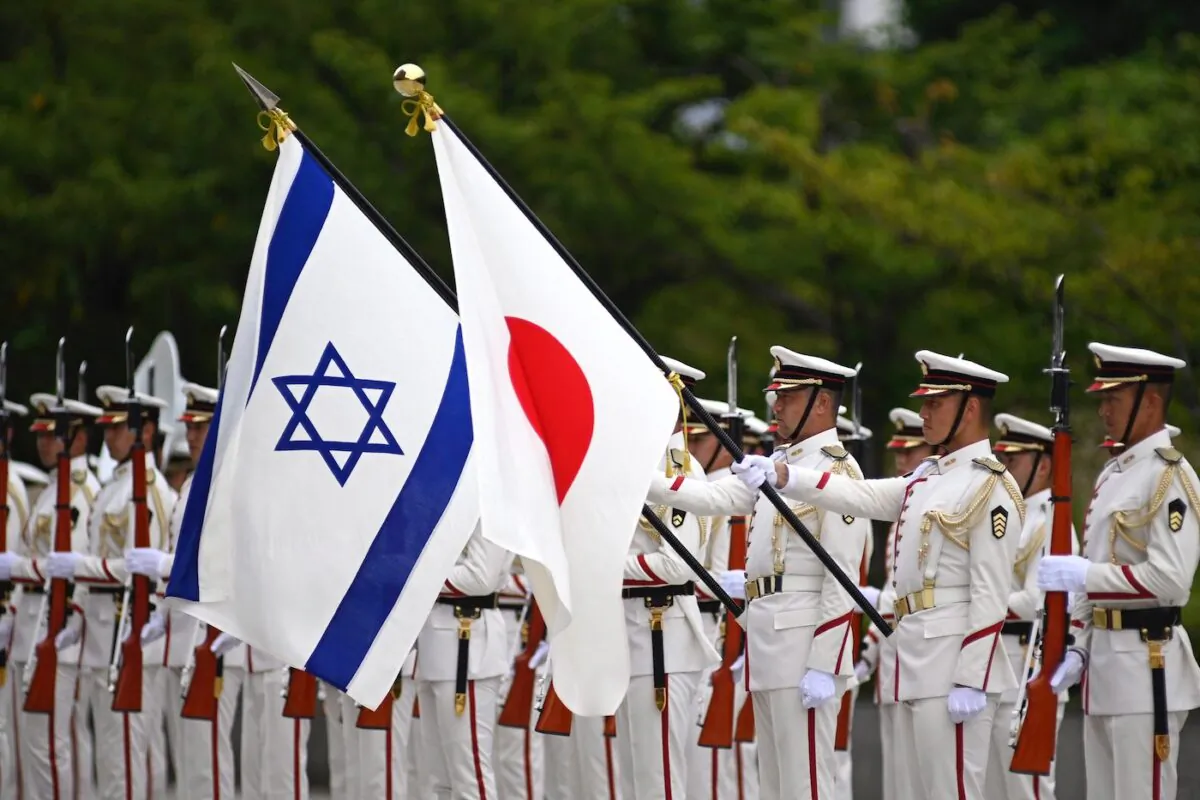 Israeli and Japan national flags flutter in the wind as Israeli Defense Minister Benny Gantz and Japanese Defense Minister Yasukazu Hamada attend an honor guard ceremony ahead of a bilateral meeting in Tokyo on Aug. 30, 2022. (David Mareuil/POOL/AFP via Getty Images)