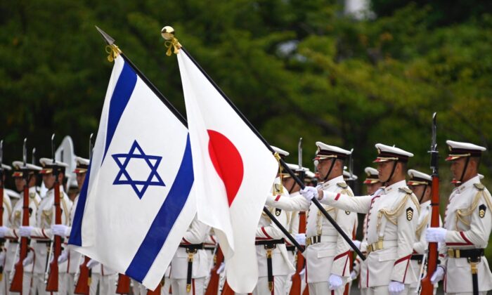 Israeli and Japan national flags flutter in the wind as Israeli Defense Minister Benny Gantz and Japanese Defense Minister Yasukazu Hamada attend an honor guard ceremony ahead of a bilateral meeting in Tokyo on Aug. 30, 2022. (David Mareuil/POOL/AFP via Getty Images)
