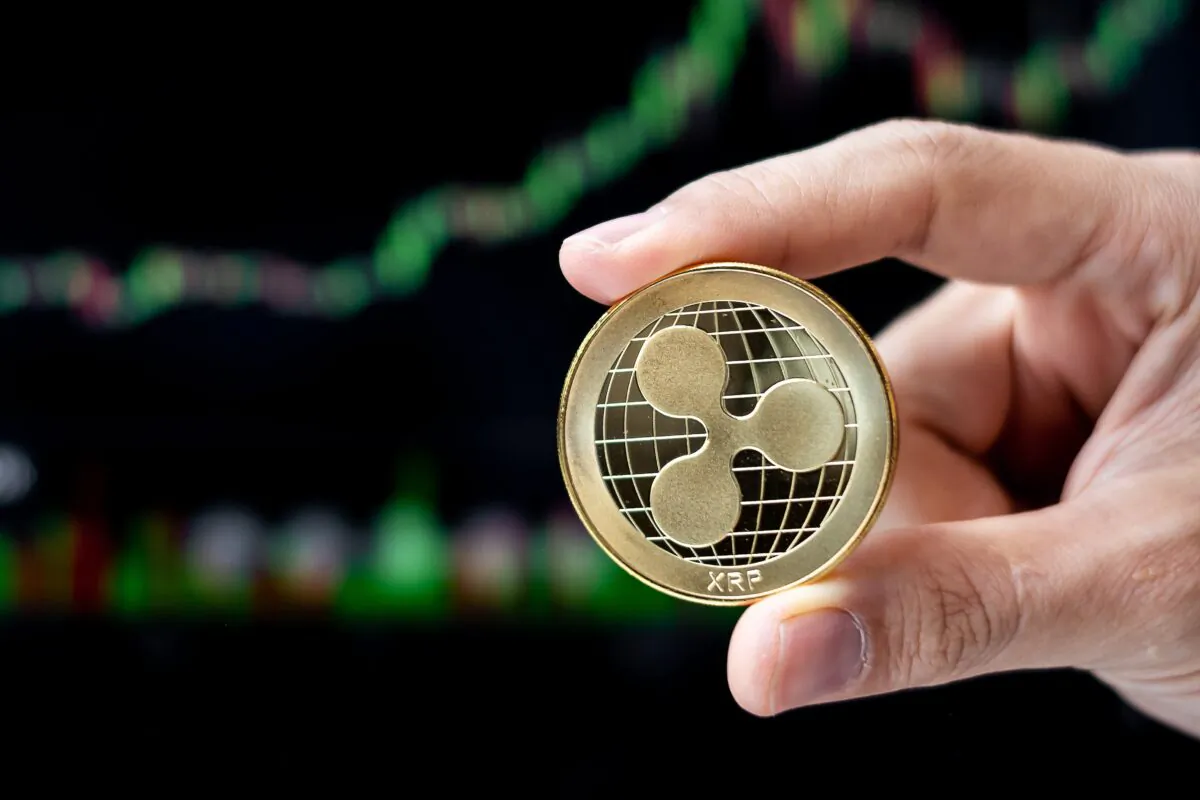 Golden Ripple (XRP) cryptocurrency coin with candle graph background, Crypto is Digital Money within the blockchain network, is using technology and online internet exchange. (Jo Panuwat D/Shutterstock)