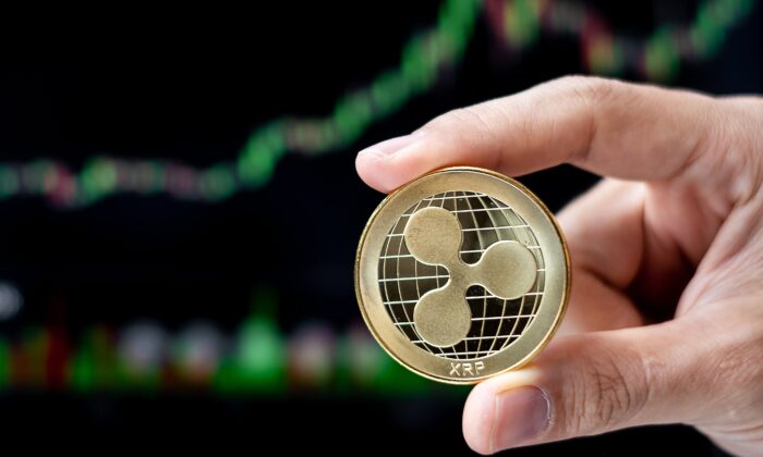 Golden Ripple (XRP) cryptocurrency coin with candle graph background, Crypto is Digital Money within the blockchain network, is using technology and online internet exchange. (Jo Panuwat D/Shutterstock)