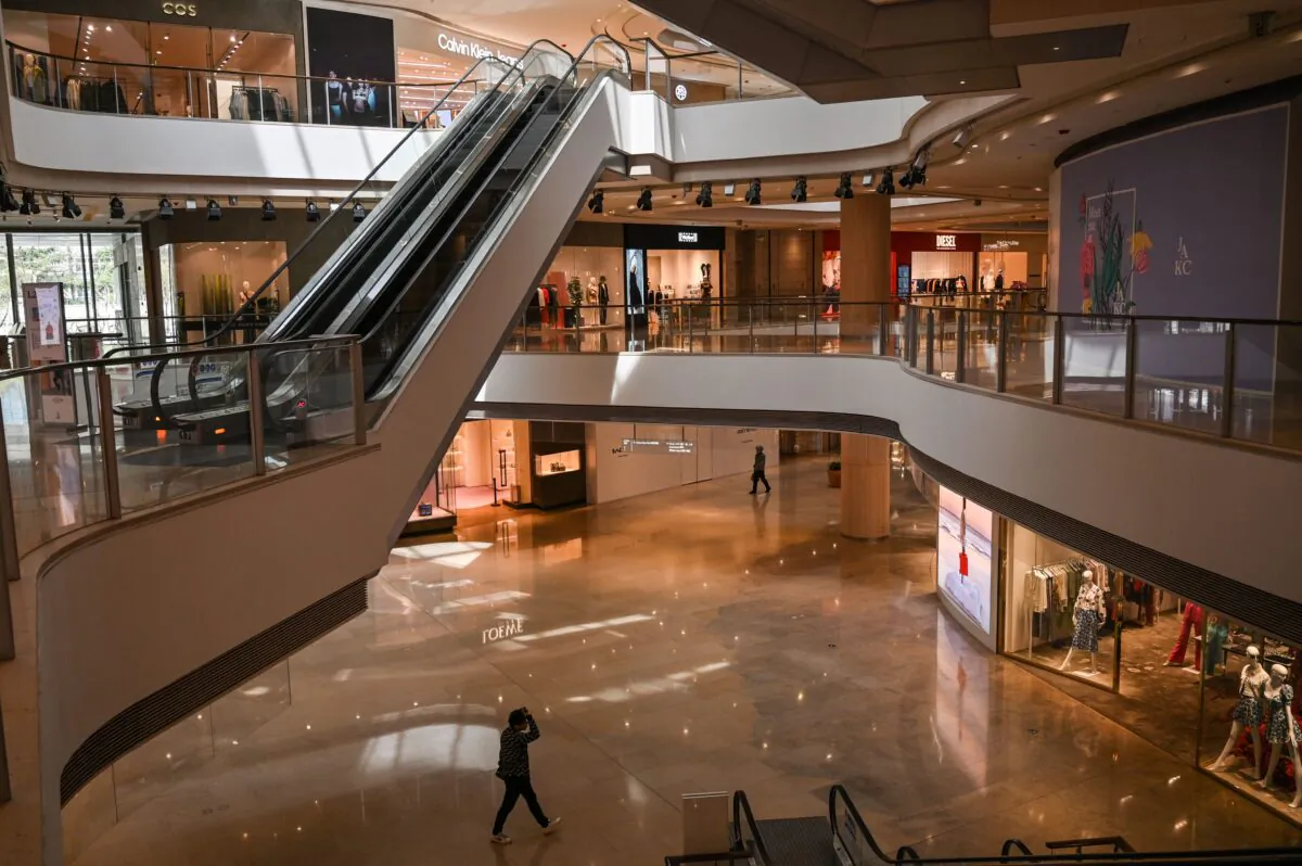 People walk in a shopping mall in Jingan district in Shanghai, China, on March 16, 2022. (Hector Retamal/AFP via Getty Images)