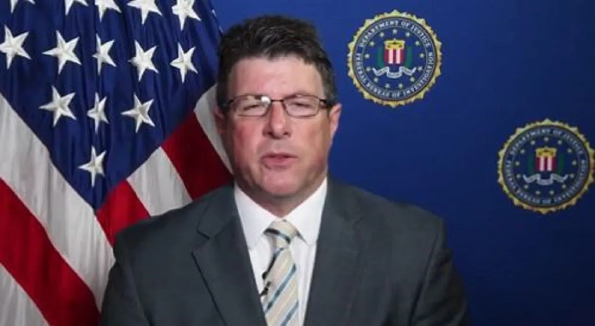 In a still image from video, Timothy Thibault speaks against an FBI backdrop. (FBI via The Epoch Times)