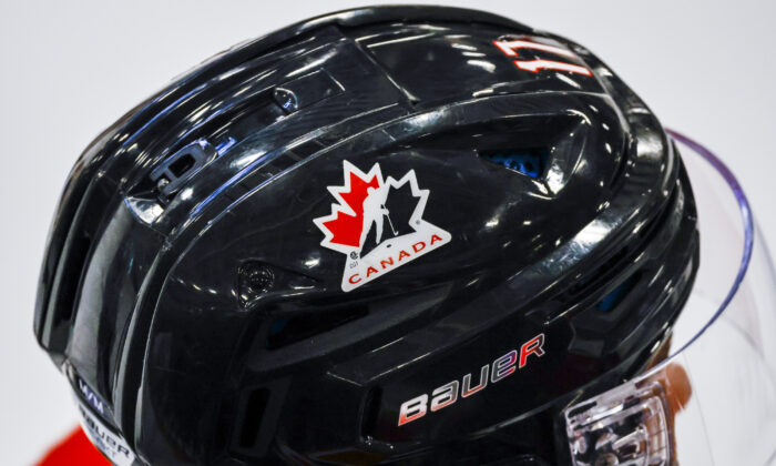 A Hockey Canada logo is visible on the helmet of a national junior team player during a training camp practice in Calgary on Aug. 2, 2022. (The Canadian Press/Jeff McIntosh)