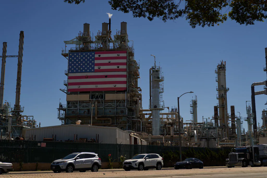 An oil refinery displays an American flag in Wilmington, Calif., on Sept. 21, 2022. (Allison Dinner/Getty Images)